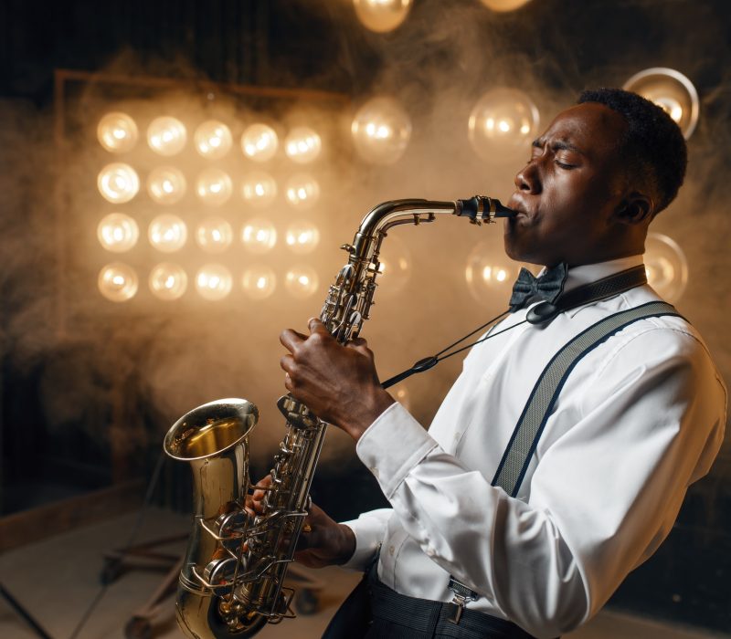 Black jazz performer plays the saxophone on stage