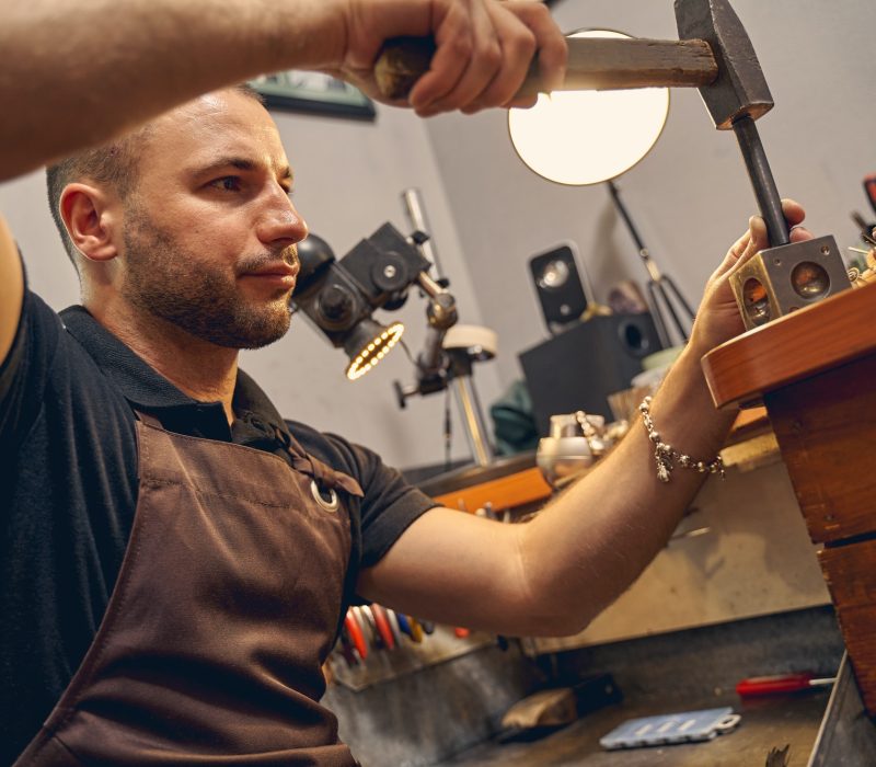 Focused skilled craftsman working with a hammer